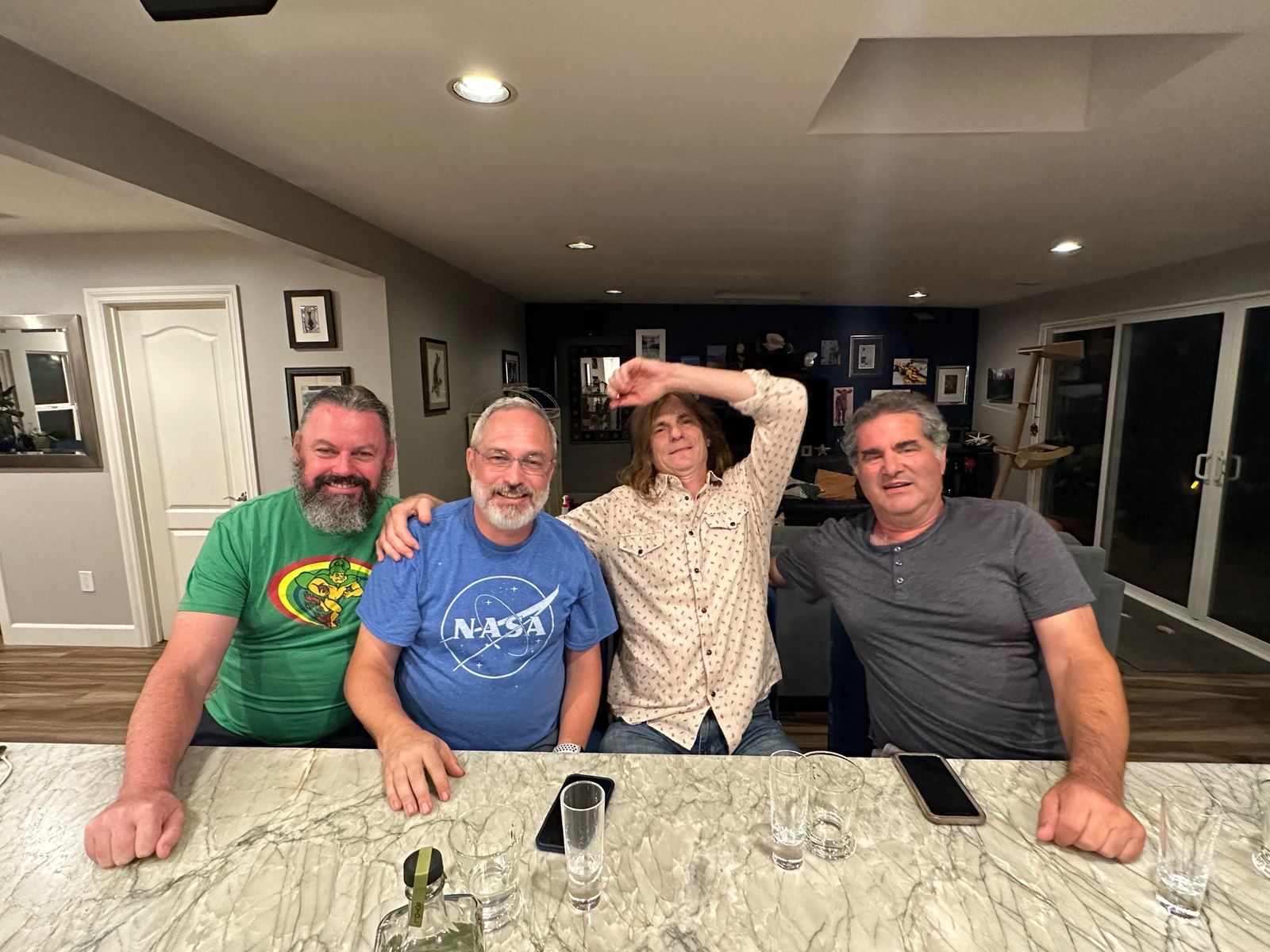 Alan and three friends at a bar counter