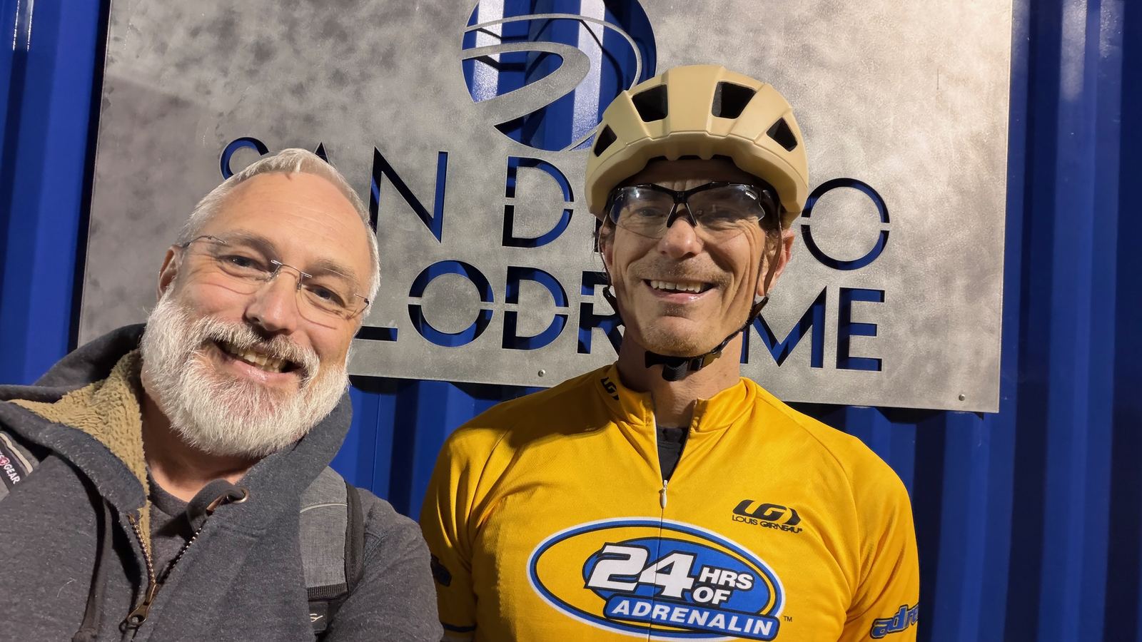 Alan in yellow cycling jersey and helmet at the San Diego Velodrome